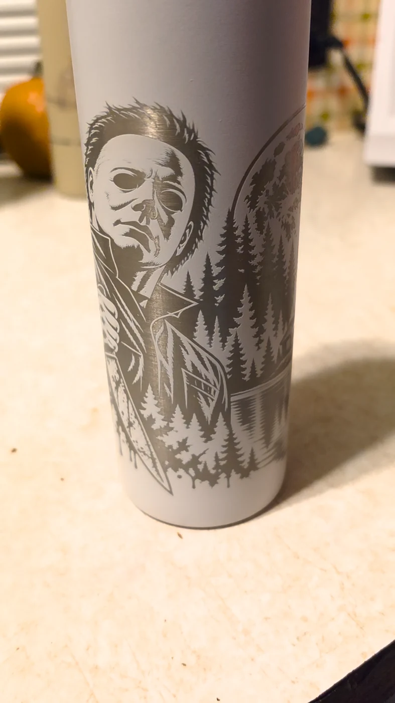 Detailed laser engraving on a gray tumbler